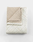 Folded cream and light beige quilt with stitched diamond pattern, Amity Home Mendel collection, handmade style.