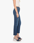 Mother The Mid Rise Hiker Hover fray jeans in blue denim styled with a white top and sandals against a white backdrop.