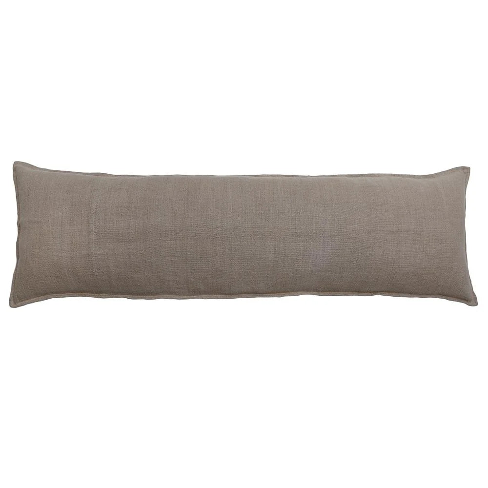 The Montauk Body Pillow by POM POM features a long, rectangular shape and a plain light brown heavyweight linen cover, displayed on a white background.