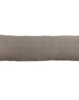 The Montauk Body Pillow by POM POM features a long, rectangular shape and a plain light brown heavyweight linen cover, displayed on a white background.