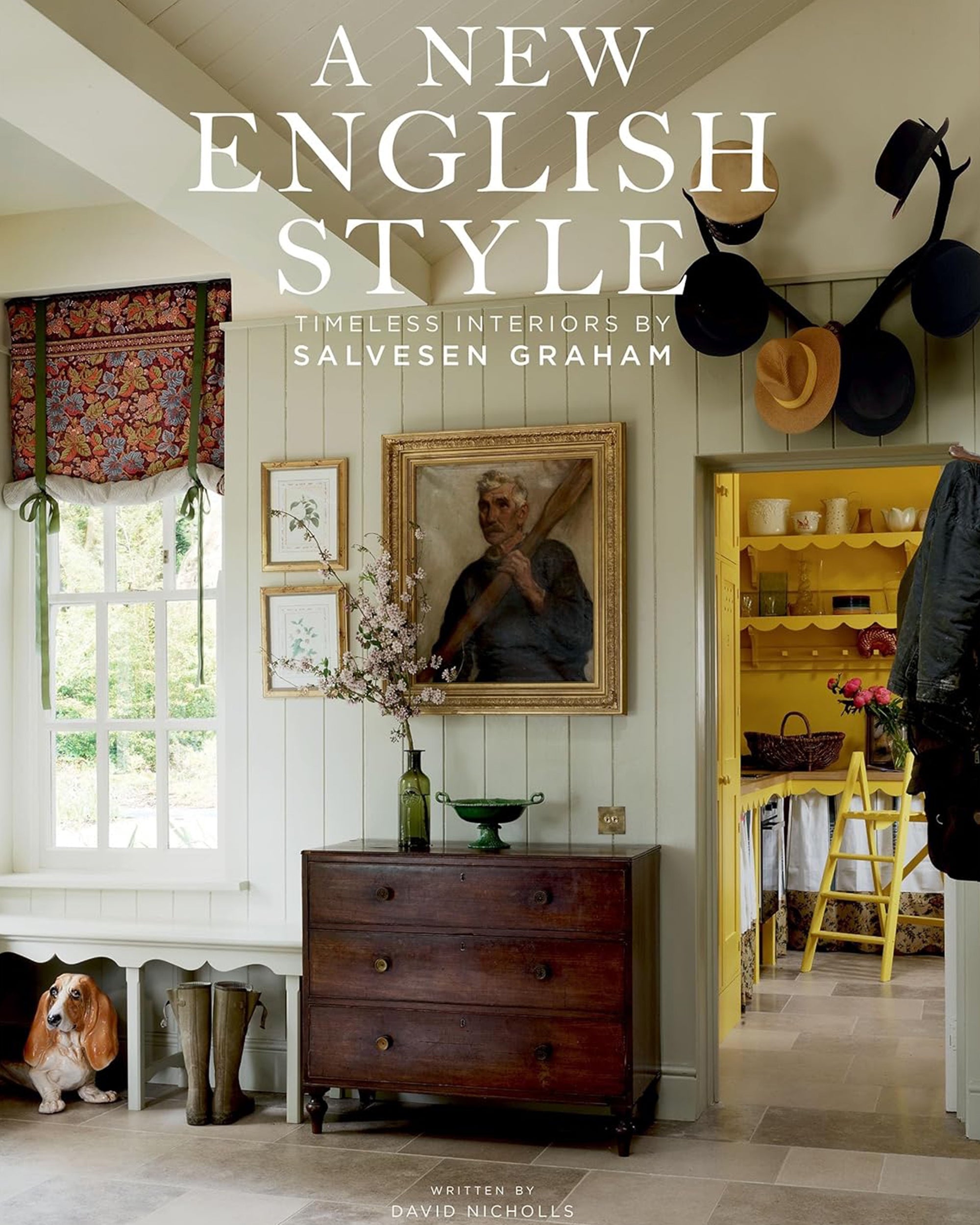Cover of "New English Style" by Hachette Book Group shows a cozy, English country-inspired interior with a dog statue, bench, hats on the wall, framed art, flowers in a vase, and a view into a yellow pantry. Text overlays the image.