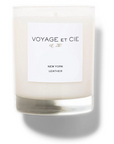 A 14 OZ Classic Highball soy coconut blend candle by Voyage Et Cie in a clear glass with a white "VOYAGE ET CIE est. 2005 NEW YORK LEATHER" label, unlit and displayed against a plain white background.