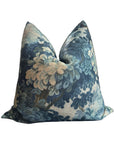 Blue and cream floral Faire Nola pillow with woven, soft-textured cover, pictured on white background.