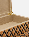 A close-up of the Made Goods Zion Hair on Hide Box, an open rectangular piece lined with beige fabric and gold hinge, showcasing a geometric black zigzag pattern on its exterior.