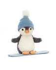 The Jelly Cat Inc. Peanut Penguin Snowboarding plush toy features a white belly, gray wings, orange feet and beak, and a blue knit hat with a white pom-pom, standing on a light blue mat against a white background.