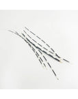 Outpost Original Porcupine Quills: Long, thin African quills with black and white bands are arranged on a white background—perfect for jewelry making or as unique natural craft supplies.