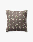 The Poise Mauve Pillow 20x20 by Loloi Rugs is a square pillow with a dark gray base and a repeating floral pattern in white, yellow, and green, plus a hidden antique bronze-finish zipper.