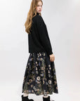 Psophia 2894 black skirt styled with matching top and boots, Bungalow Furniture & Accessories, minimal backdrop.