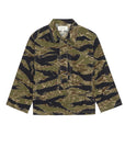 The Great Inc. Railway Shirt is a long-sleeved, collared shirt with a green, brown, and black tiger stripe camo inspired by vintage workwear, featuring a front placket and relaxed fit.