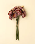 The Indaba 01-9478 Ranunculus Bouquet features mauve and dusty pink ranunculus flowers with green stems, tied with a tan band—ideal for displaying in decorative vases as a charming floral arrangement.