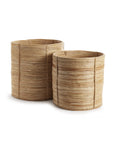 Two RATTAN ROUND BASKETS by Napa Home & Garden, one taller and wider than the other, showcase a youthful cylindrical design—perfect for adding stylish flair to your interiors.