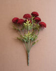 Red dahlias with green leaves on 18-inch stems by Kalalou, set against a plain brown background.
