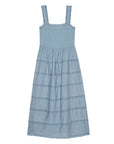 The Reverie Dress by The Great Inc. is a sleeveless light blue cotton midi dress with wide straps, a square neckline, horizontal lace details, a gathered waist, and a scalloped hem. Dry clean recommended.