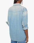 Oversized light blue denim button-up shirt and jeans by Mother, relaxed fit with rolled sleeves, casual style.