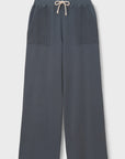 The Perfectwhitetee French Terry Pant is a wide-leg, navy cotton pant with an elastic waistband, beige drawstring, and two large textured front pockets. Pants are shown laid flat on a white background.