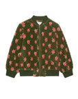 The Great Inc. Zip Front Plush Bomber is an army green fuzzy jacket with a front zipper, ribbed cuffs, collar, and hem, adorned with a rose pattern of pink and red flowers with green leaves.