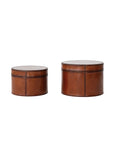 Two round, cognac-colored DG0045 Leather Boxes by Creative Co-op made of MDF & leather with stitched details are shown on a white background. One is smaller; both feature flat lids and soft, flocked interiors for protection.