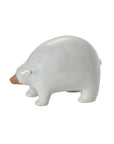 The Ceramic Polar Bear by Accent Decor is a minimalist white figurine with a brown snout, shown in profile on a plain background—a charming piece for any Arctic-inspired collection.