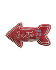 The Creative Co-op Santa Please Stop Pillow is a festive red arrow-shaped cotton lumbar pillow with white trim and embroidered text—ideal holiday decor for Christmas.