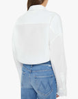A person is shown from the back wearing Mother’s The Scrunchie Frenchie—an untucked white cotton top with long wide sleeves and light blue jeans featuring “V”-stitched pockets.