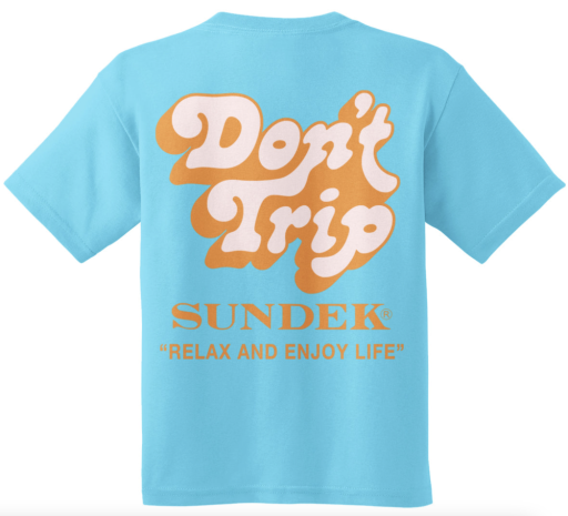 A turquoise T-shirt features "Don't Trip" in bold white and orange letters, with the brand "SUNDEK/KickoffUSA" and slogan "RELAX AND ENJOY LIFE" in smaller orange text.