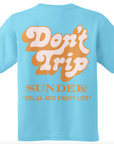 A turquoise T-shirt features "Don't Trip" in bold white and orange letters, with the brand "SUNDEK/KickoffUSA" and slogan "RELAX AND ENJOY LIFE" in smaller orange text.