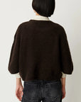Sessun Tallon dark brown long sleeve sweater styled with black jeans, modern casual look.
