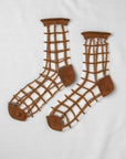 The Unified Sheer French Window socks feature a brown, grid-style net pattern with solid brown toe, heel, and cuffs, shown on a white background.