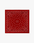 The Silk Bandana from The Great Inc. is a red silk accessory with classic white and black paisley patterns, including detailed symmetrical floral designs, shown on a plain white background.