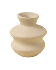 The Indaba Wave Paper Mache Bud Vase features a beige matte finish, handcrafted wavy shape with three bulging sections and a narrow opening—ideal for sustainable decor. Shown against a white background.