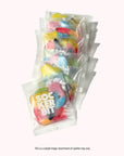 Several individually wrapped packs of Faire Sockerbit Single Serve Swedish candy, in bright colors and fun shapes, are arranged in a row. These GMO free treats are perfect for single servings.