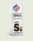 A clear, rectangular box labeled "Speks- Matte Spectrum" by Faire holds small, colorful magnetic balls stacked in a cube. The box says "S. spectacularly magnetic."—great for stress relief and building geometric shapes.