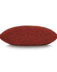 The Eastern Accents Marl Brick Pillow is a rectangular decorative piece in burnt orange with a textured boucle fiber finish, displayed from the side against a white background.