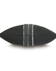 The Eastern Accents Modesta Grommet Border pillow showcases a rectangular black design with a central gray strip, shiny sequins, and elegant border trim, displayed against a white background.