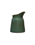 The Creative Co-op DF6763 Stoneware Creamer is a small green vessel with a wide base, narrow top, and spouted lip, featuring a reactive glaze and displayed against a white background.