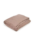 The Swimmer Stripe Super King blanket by Libeco Home features a subtle textured pattern and washed finish in light brown, shown folded on a white background.