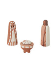 The Pintura Nativity by Accent Decor includes three handmade ceramic figurines—a striped-robed woman, a staff-holding man, and a baby in a manger—in warm brown and white tones, perfect for your Christmas Nativity scene.