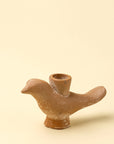 The Indaba Wren Candle Holder is a small, brown, ceramic bird-shaped piece with a round back opening, perfect for adding rustic charm to your decor. Shown here against a plain beige background.