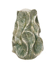 The Green Floral Texture Vase by Bloomingville is a round stone vase with a wavy, textured surface and an embossed green and white palm leaf pattern, making it a striking decorative accent for any space.