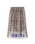 The Hailey Printed Skirt by Me369 is a knee-length viscose satin skirt featuring a leopard print, striped borders, and bold "TIGER STYLE" lettering along the hem; it fits true to size for easy addition to any women’s wardrobe.