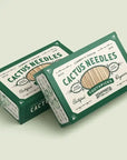 Two green-and-white boxes of Faire’s Cactus Needle Toothpicks, featuring vintage designs and organic bamboo picks. Hand-picked in Mexico, these make a unique Southwest souvenir.