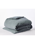 The Toro Canyon Org. Duvet Cover Marine King by Coyuchi Inc is shown neatly folded on a white surface, highlighting its soft organic cotton and subtle textured weave in a soothing gray-blue tone.