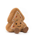 The Amuseables Tree Cookie by Jelly Cat Inc. is a plush Christmas tree cookie with brown fuzzy fabric, white icing trim, colorful dots, a smiling face, and brown corduroy feet—ideal for gifting or festive displays.