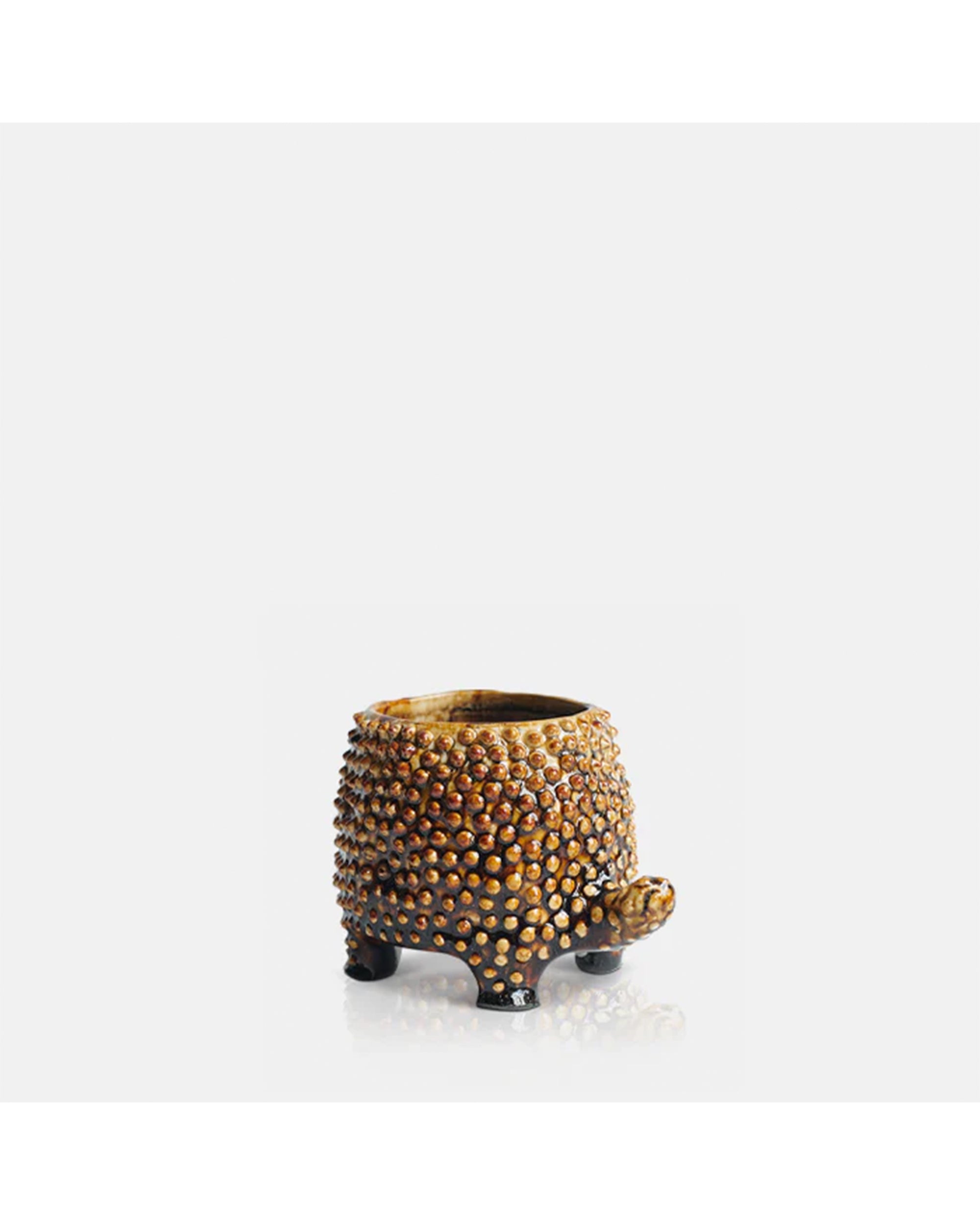 The Abigail Ahern C13-004 Tortoise Small Pot is a textured brown ceramic plant pot, shaped like a tortoise with four short legs and a rounded body, shown on a plain white background.