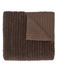 The John Robshaw Velvet Coverlet King features a folded, quilted brown velvet design with a soft, textured surface and smooth underside, hand quilted for a cozy, plush feel.
