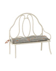 Vintage-style bench with curved backrest and floral cushion by Maileg, perfect for cozy living spaces.