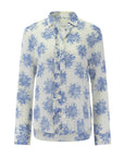 The Waterfall Shirt by Cissa is a long-sleeve, button-up blouse with a white base and light blue floral print, featuring Trocas shell buttons, a collar, and a curved hem.