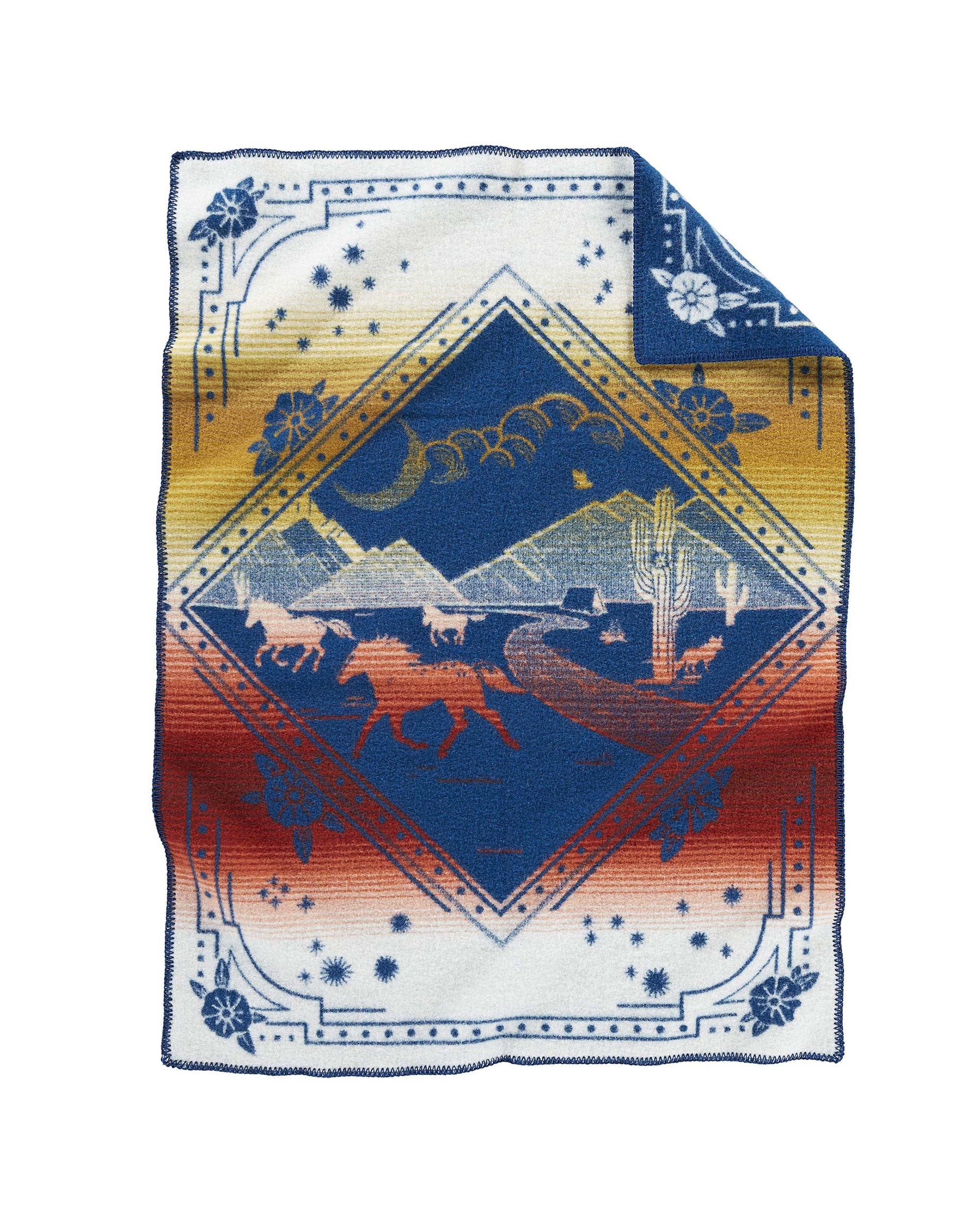 The Pendleton Jacquard Whipstitch Muchacho baby blanket features a desert scene with horses, cacti, and mountains inside a diamond on a white-to-red background with blue borders. Customizable embroidery available. Sold by Babbitt's Wholesale.
