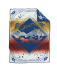 The Pendleton Jacquard Whipstitch Muchacho baby blanket features a desert scene with horses, cacti, and mountains inside a diamond on a white-to-red background with blue borders. Customizable embroidery available. Sold by Babbitt's Wholesale.
