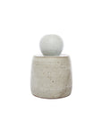 The Faire Alabaster White Stash Jar features a minimalist, speckled light gray stoneware body with a matching domed lid, matte glaze finish, and is displayed against a plain white background.